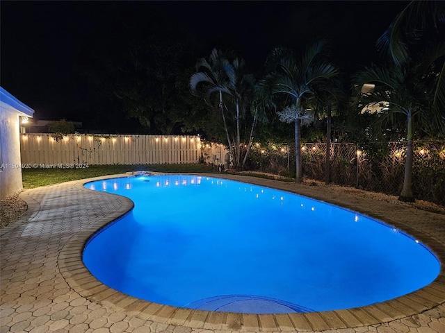 view of pool at night