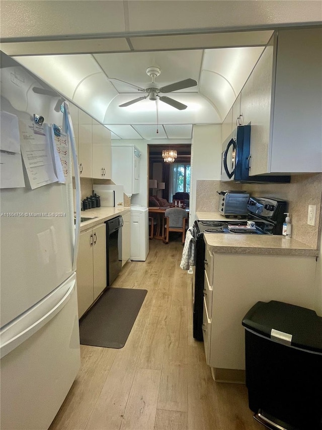 kitchen with white cabinets, black appliances, light hardwood / wood-style flooring, and ceiling fan with notable chandelier