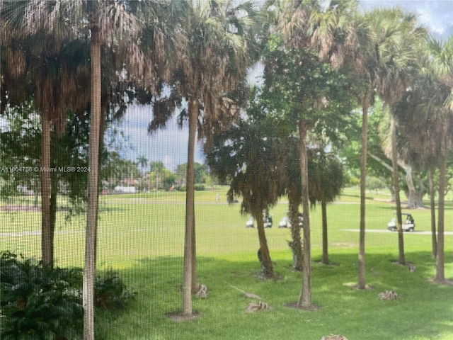 surrounding community featuring a lawn and a water view