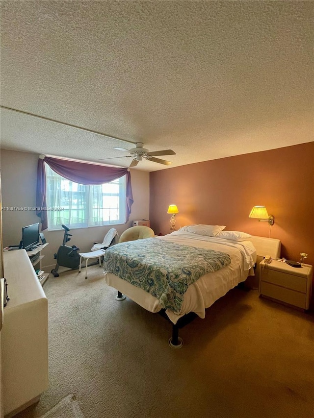 carpeted bedroom featuring ceiling fan and a textured ceiling