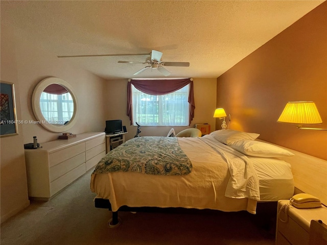 carpeted bedroom with ceiling fan and a textured ceiling