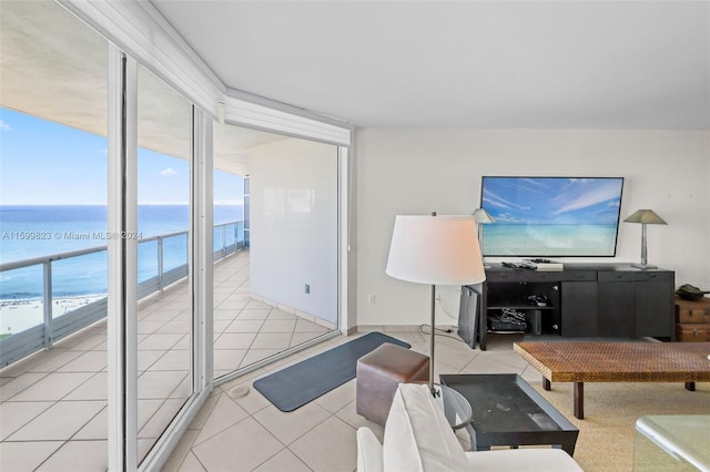 tiled living room with a beach view and floor to ceiling windows