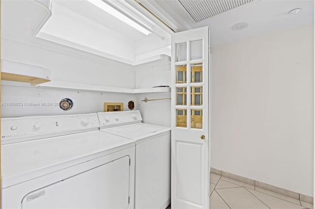 laundry area with light tile patterned floors and separate washer and dryer