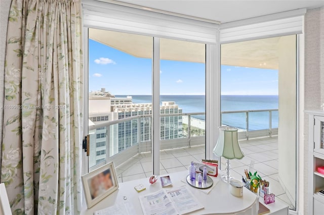 unfurnished sunroom featuring a water view