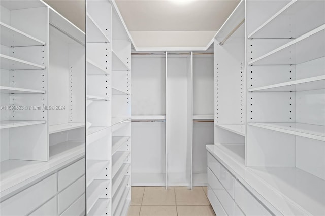 spacious closet with light tile patterned floors