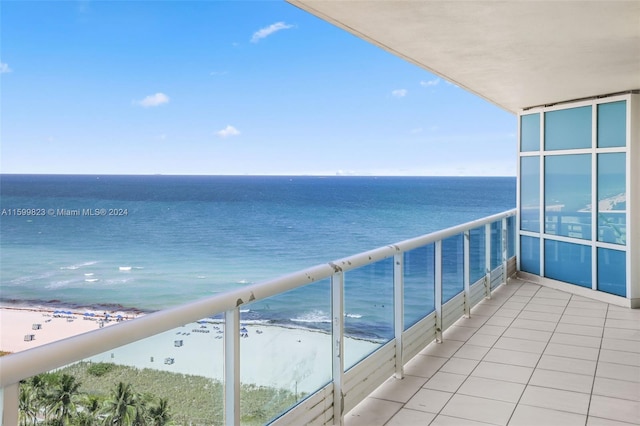 balcony with a water view and a beach view