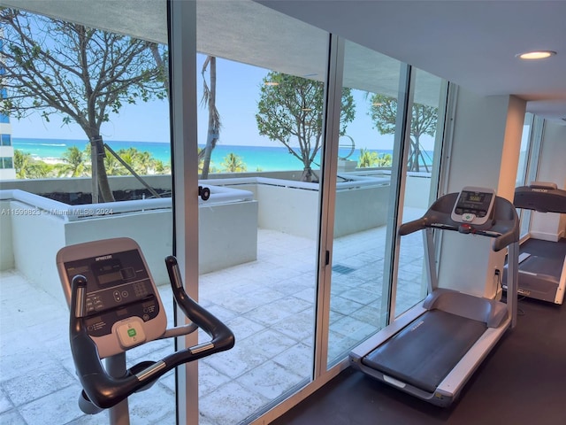 exercise room with a water view