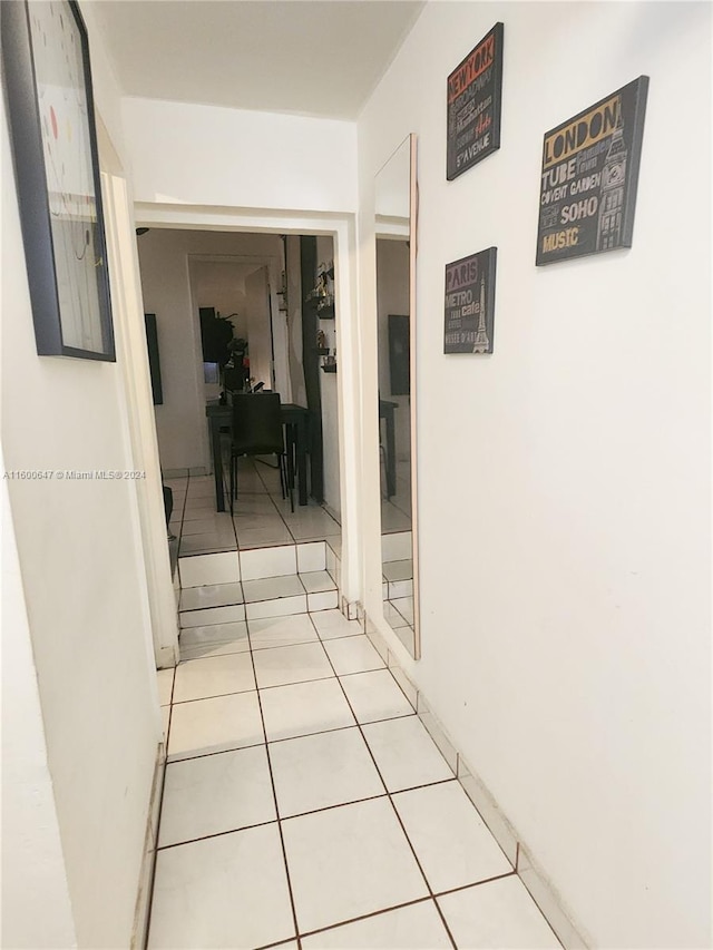 corridor featuring light tile patterned floors