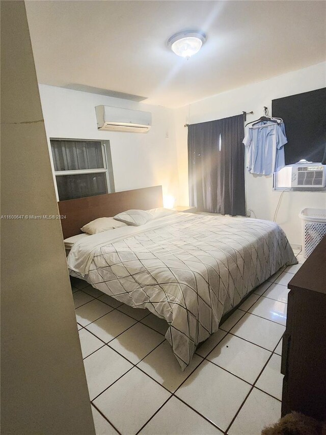 tiled bedroom featuring a wall mounted air conditioner and cooling unit