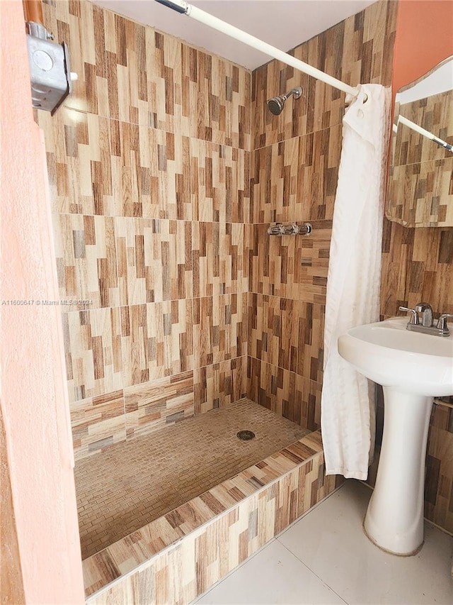 bathroom with tile patterned floors, a shower with curtain, and sink