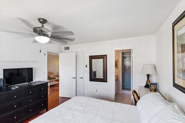 bedroom featuring ceiling fan, a closet, connected bathroom, and hardwood / wood-style floors