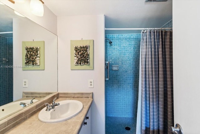 bathroom featuring a shower with shower curtain and vanity