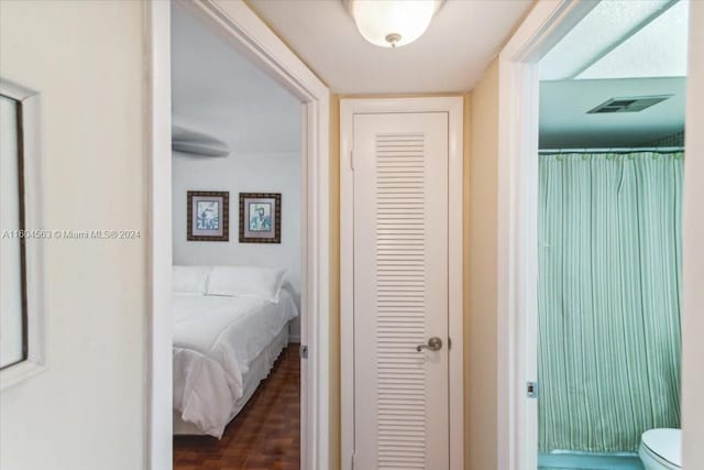 corridor with dark hardwood / wood-style floors