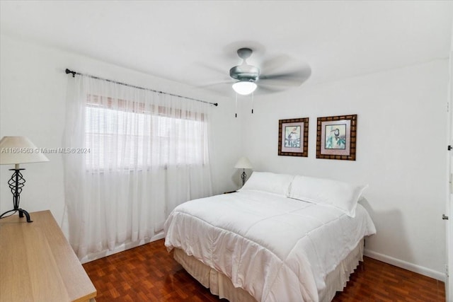 bedroom with ceiling fan and hardwood / wood-style flooring