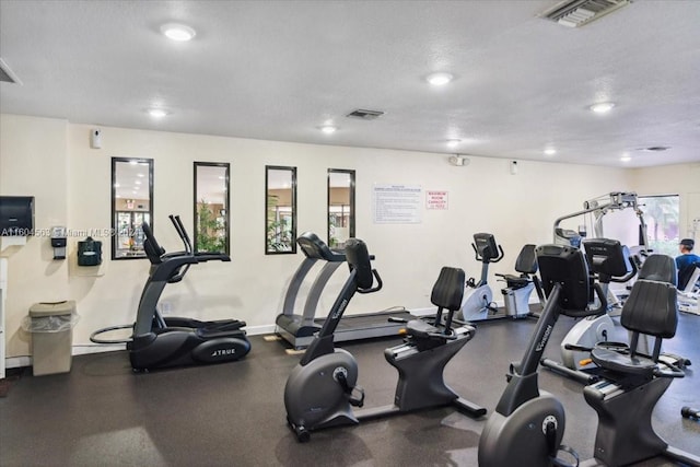 exercise room with a textured ceiling