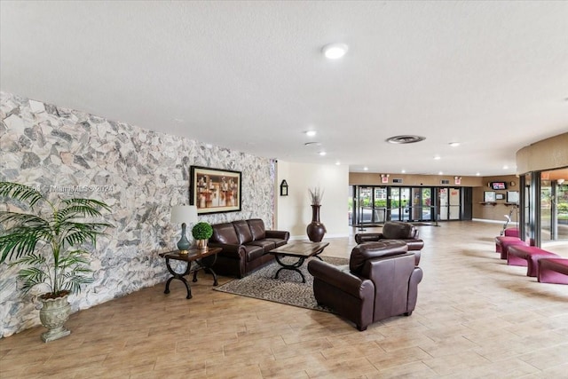 living room with a textured ceiling and light tile floors