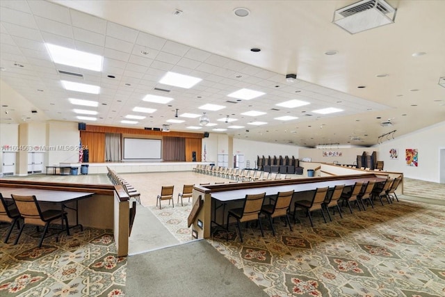 dining space featuring carpet and a paneled ceiling