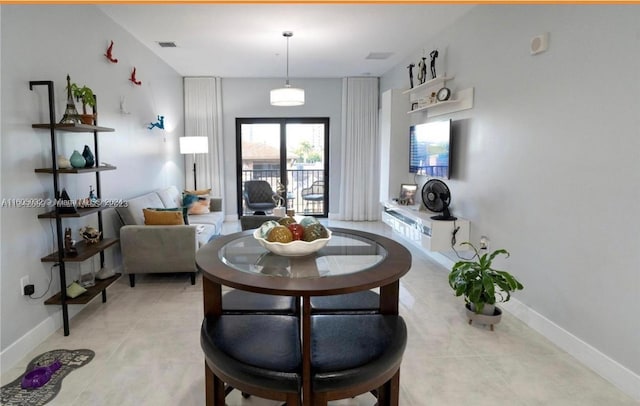 dining area featuring light tile floors