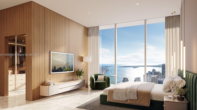 bedroom with floor to ceiling windows, wood walls, a water view, and light tile flooring