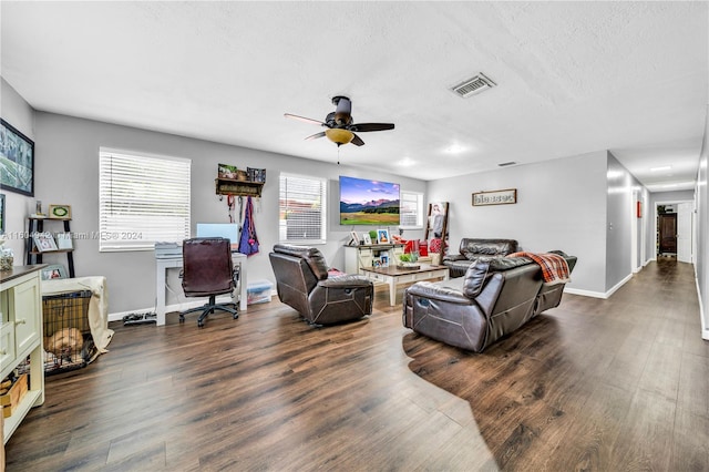 living room with dark hardwood / wood-style flooring and ceiling fan