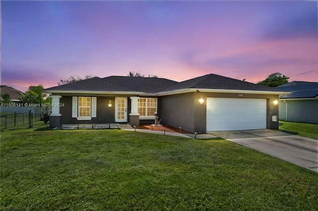 view of front of property featuring a yard and a garage