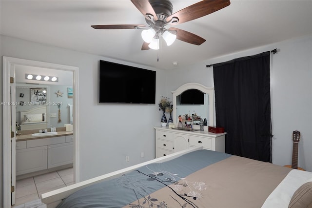 tiled bedroom featuring connected bathroom, ceiling fan, and sink