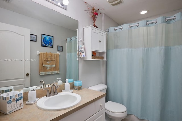 bathroom with vanity, toilet, and walk in shower