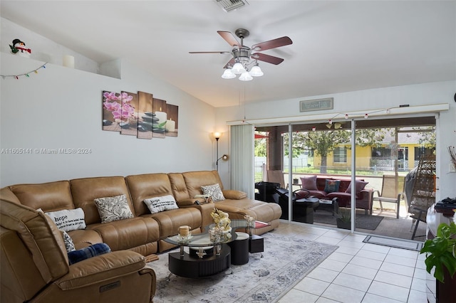 living room with lofted ceiling, ceiling fan, and light tile patterned floors