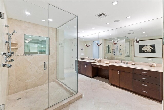 bathroom featuring a shower with shower door, vanity, and tile floors