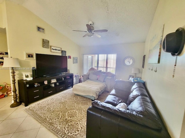 living room featuring ceiling fan, light tile patterned floors, a textured ceiling, and vaulted ceiling