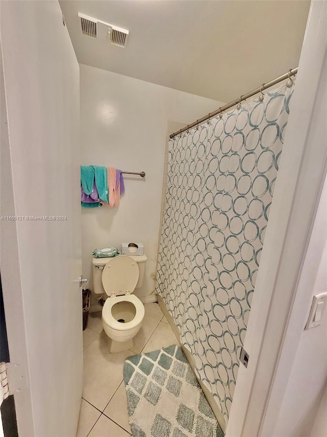 bathroom featuring tile patterned flooring and toilet