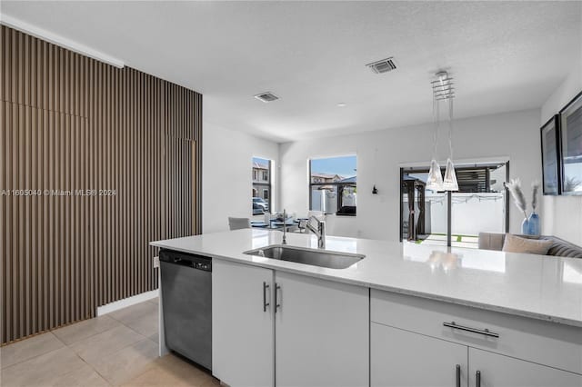 kitchen featuring light stone counters, dishwasher, white cabinetry, sink, and light tile floors