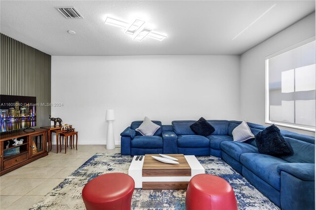 living area with tile patterned flooring and visible vents