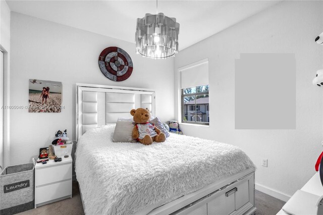 bedroom featuring carpet and a chandelier