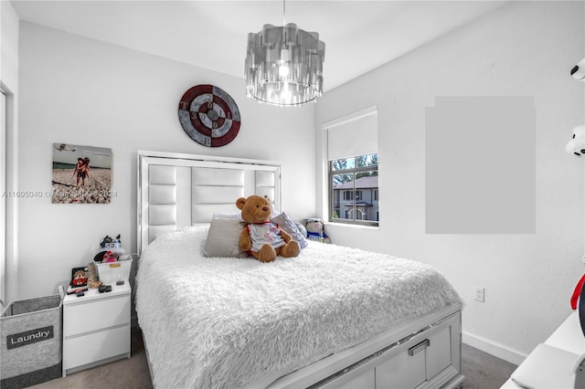 bedroom featuring a chandelier, carpet, and baseboards