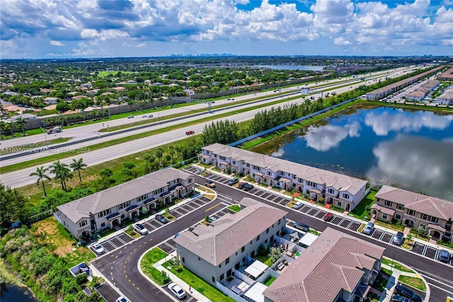 bird's eye view featuring a water view and a residential view