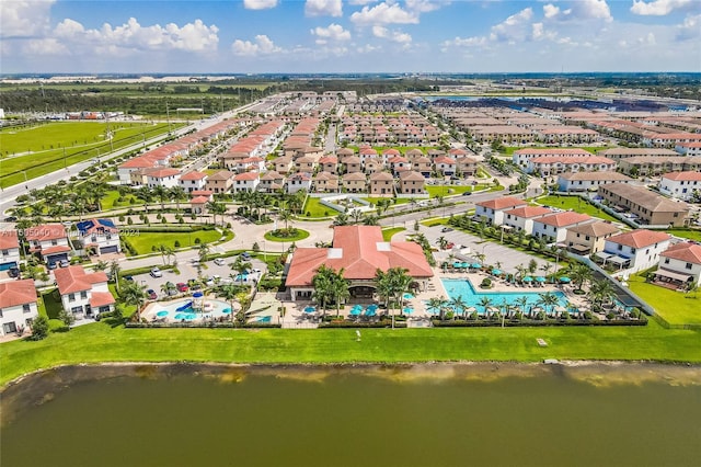 birds eye view of property with a water view and a residential view