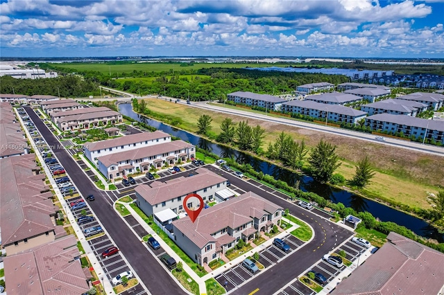 drone / aerial view featuring a residential view and a water view