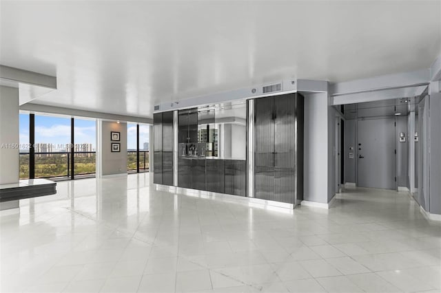 tiled spare room featuring expansive windows