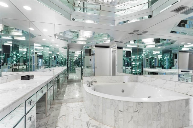 bathroom with a relaxing tiled bath, vanity, and tile floors