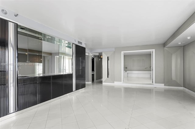 unfurnished room with light tile floors