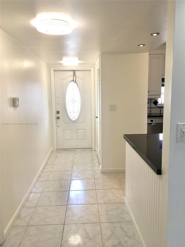 doorway to outside featuring light tile patterned floors