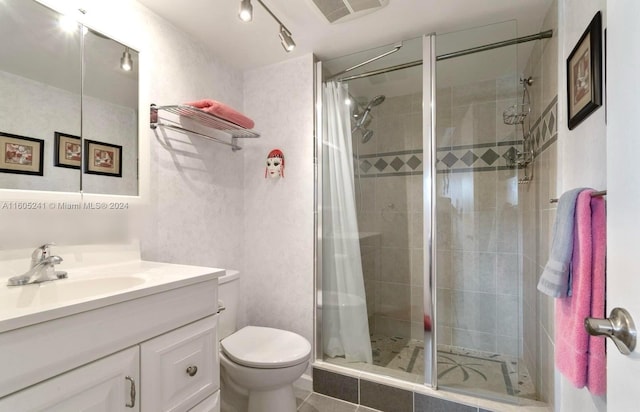 bathroom with tile patterned floors, vanity, walk in shower, and toilet