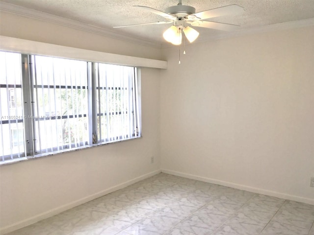 empty room featuring a textured ceiling, tile patterned floors, a wealth of natural light, and ceiling fan