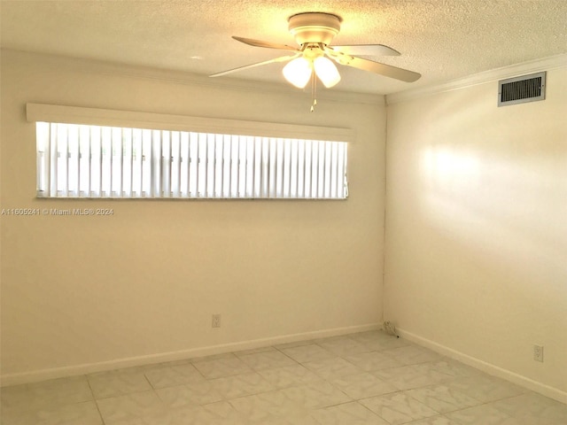 tiled spare room featuring a textured ceiling, ceiling fan, and ornamental molding