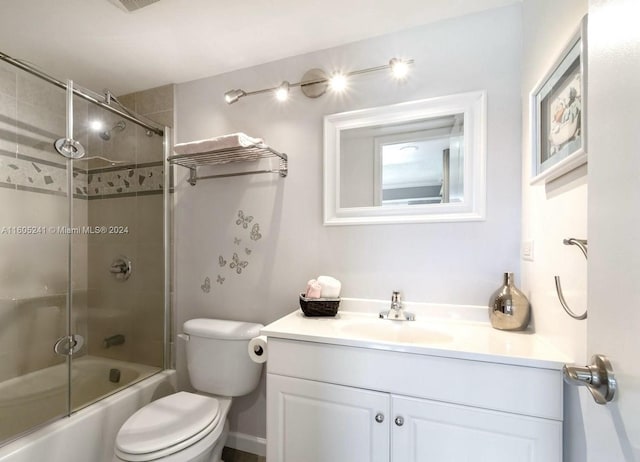 full bathroom featuring toilet, shower / bath combination with glass door, and vanity