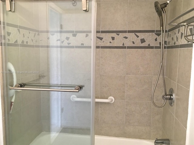 bathroom with shower / bath combination with glass door