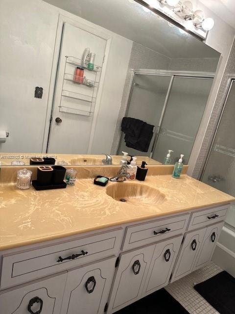 bathroom with vanity and a shower with shower door