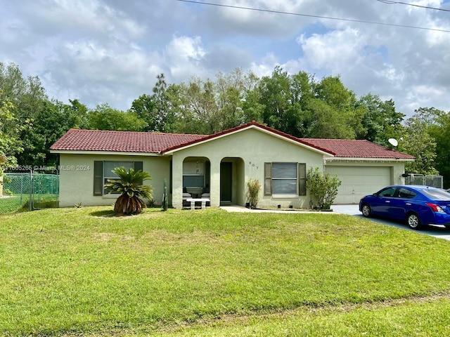 view of front of house with a garage and a front lawn