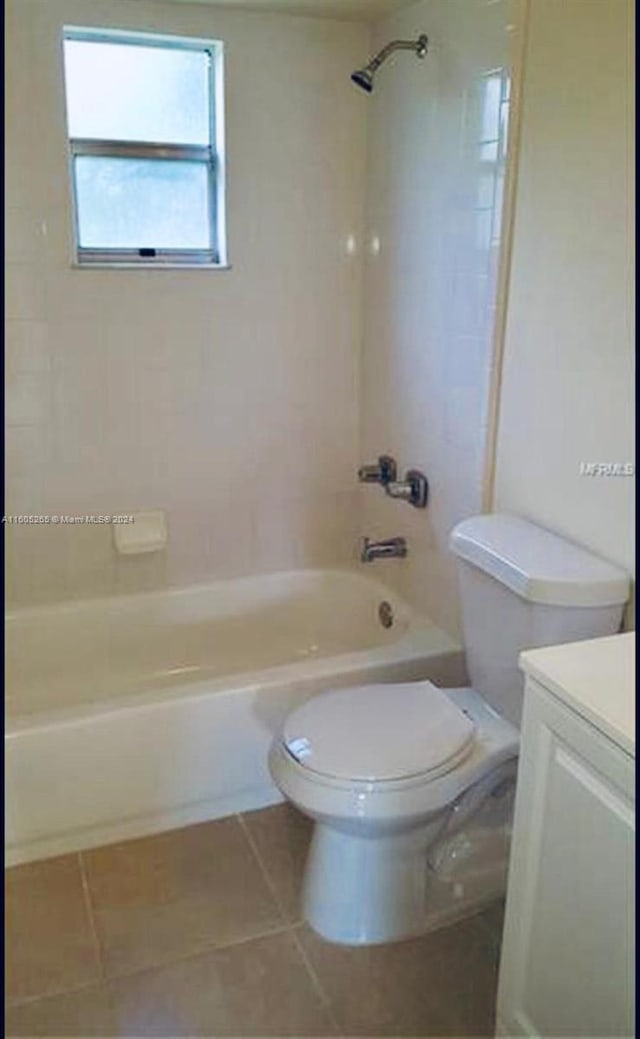 full bathroom with tile flooring, vanity, toilet, and tiled shower / bath combo